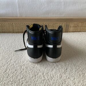 Nike Black and white leather high tops with blue Nike logo
